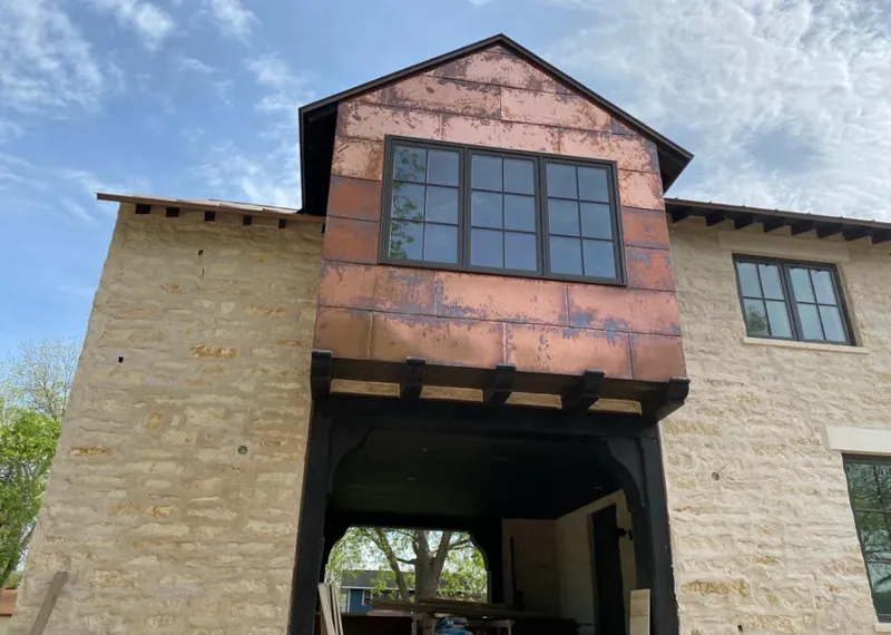 Copper metal panel facade on a stone building for Metal Roof Coating in Canutillo